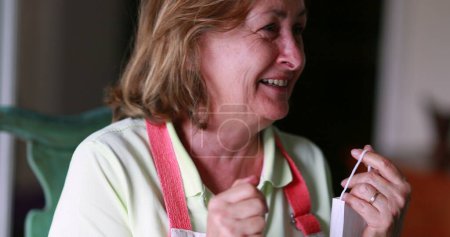 Foto de Older woman shock reaction with mood swings. Portrait of senior lady reacting with despair, laugh - Imagen libre de derechos