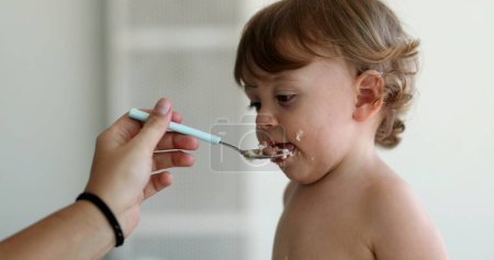 Téléchargez les photos : Cute baby child infant refusing spoon food - en image libre de droit