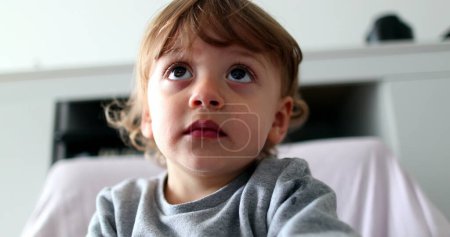 Foto de Portrait baby boy hypnotized by screen, child face watching cartoon - Imagen libre de derechos
