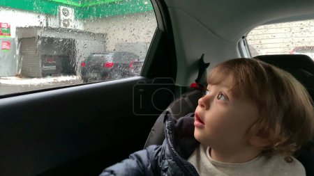 Photo for Little baby boy waiting in carseat inside car wanting to go out - Royalty Free Image