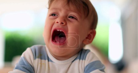 Photo for Cute baby complaining crying out loud wanting attention. Toddler yelling opening mouth - Royalty Free Image