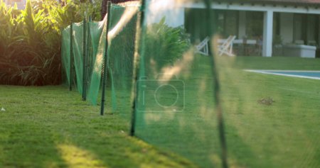 Photo for Home garden backyard wire division fence separating two houses - Royalty Free Image