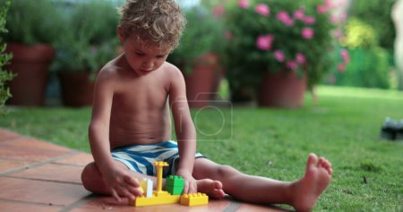Photo for Kids plays with block pieces outdoors - Royalty Free Image