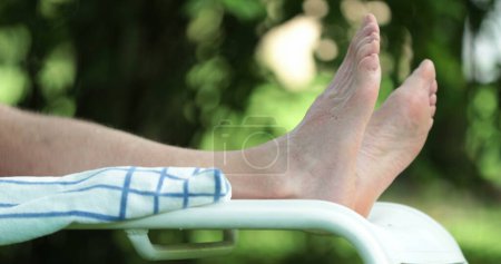 Photo for Man feet relaxing outside in nature. Closeup of person foot lying down - Royalty Free Image