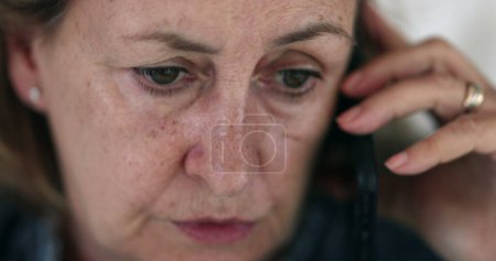 Photo for Older woman speaking on cellphone. Close-up face senior woman talking with phone - Royalty Free Image