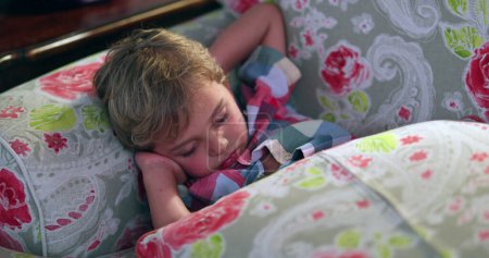 Photo for Toddler boy sleeping on sofa at night. Slouched tired child asleep - Royalty Free Image