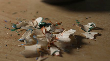 Photo for Vacuuming Rest of Pencil wooden shavings from sharpening colored pencils residue dust on table - Royalty Free Image
