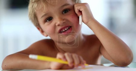 Photo for Adorable artistic child drawing on paper with coloring pen - Royalty Free Image