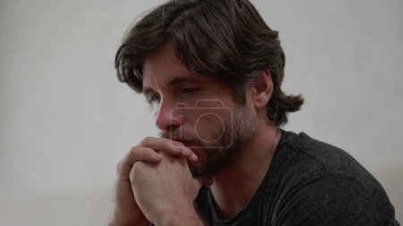 Photo for One preoccupied young man thinking deeply about life problematic issues. Worried male person in 30s with hand in chin with thoughtful expression - Royalty Free Image