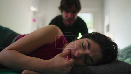 Photo for Depressed wife suffering from bad relationship while lying in bed listening to Angry husband yelling. Domestic abuse concept. Troubled in crisis in the verge of breakup - Royalty Free Image
