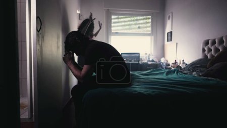 Photo for Couple Arguing and Fighting. Man feeling pressure by Female Partner. girlfriend in background discussing relationship while depressed man sits by the bedside feeling frustration - Royalty Free Image