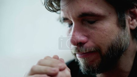 Photo for Sad tearful young man closeup face feeling depressed. Mournful male person in 30s crying from despair and hopelessness - Royalty Free Image