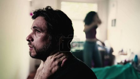 Photo for Stressed Man in Crisis. Listening to Screaming Girlfriend in Background, Boyfriend Struggling with Mental Pressure in Relationship - Royalty Free Image