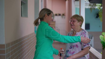 Photo for Warm family reunion, adult daughter embracing elderly mother. Generational hug, senior lady being visited by relatives - Royalty Free Image