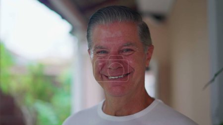 Photo for Joyful Retired Man Smiling at Camera in Home Backyard, Close-Up Tracking Shot - Royalty Free Image