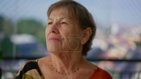 Photo for Contemplative pensive senior lady gazing at horizon with thoughtful emotion. An older caucasian woman portrait face close-up thinking about life - Royalty Free Image