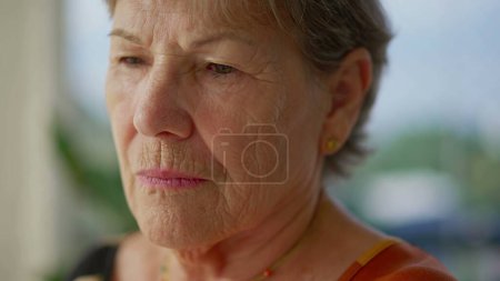 Photo for Contemplative senior woman meditating with eyes closed close-up face. An older lady in 70s opening eye awakening - Royalty Free Image