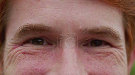 Photo for Man with serious judgemental emotion macro close-up eyes. A male person frowning looking at camera feeling angry and upset - Royalty Free Image