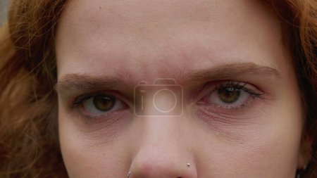Photo for Woman changing emotion, macro close-up eyes looking at camera. A female caucasian redhead person becoming serious and concerned - Royalty Free Image