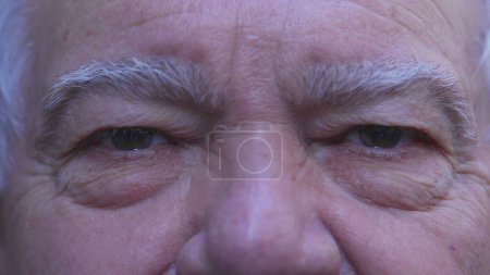 Photo for Senior man eyes with wrinkles, old age expression in macro detail close-up of a serious older male caucasian person - Royalty Free Image