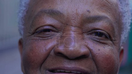 Photo for Macro close-up of a joyful black Brazilian woman eyes smiling at camera - Royalty Free Image