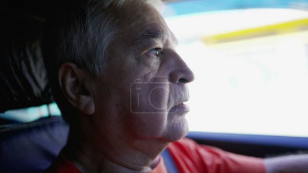 Photo for Profile close-up face of a senior driver on road. Elderly person commuting in city, interior shot of vehicle - Royalty Free Image