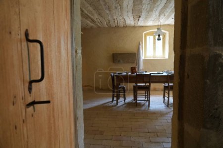 Foto de Dentro de una vieja puerta en una casa de piedra con suelos bronceados, austera simplicidad, una vieja puerta de granero de los comedores. Campo suizo - Imagen libre de derechos