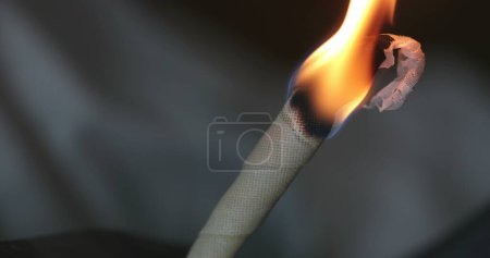 Photo for Burning cone ear wax removal ear candling - Royalty Free Image