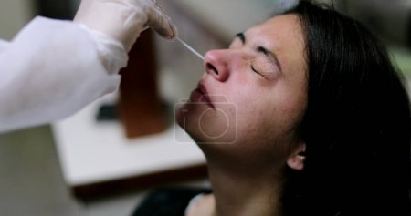 Photo for Woman having COVID nose test PCR procedure - Royalty Free Image