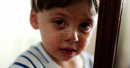 Photo for Portrait of sad tearful child face looking at camera - Royalty Free Image