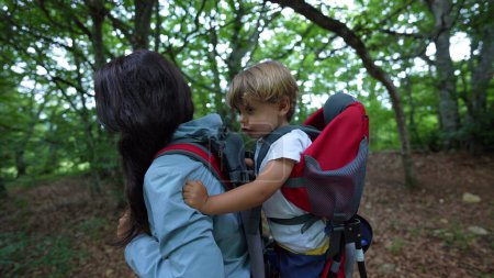 Photo for Mother hiking with child in backpack mom carrying kid in back while trekking - Royalty Free Image
