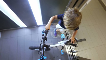 Photo for Child going out with bicycle leaving elevator kid leaves elevator - Royalty Free Image