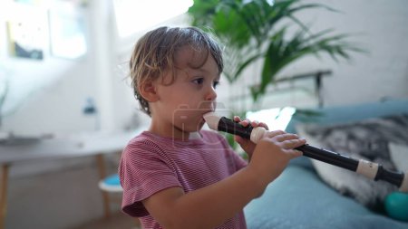 Photo for Two little boys playing flute musical tune together - Royalty Free Image