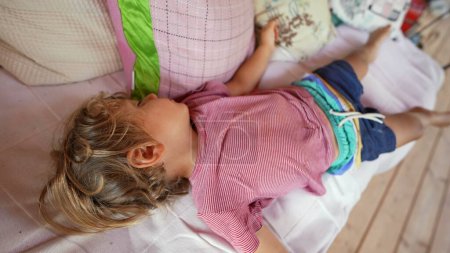 Photo for Sleeping child lying on sofa asleep in afternoon nap - Royalty Free Image