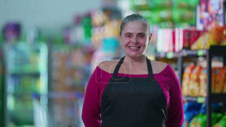 Photo for Joyful female worker of Grocery Store wearing apron and smiling at camera. job occupation staff employee - Royalty Free Image