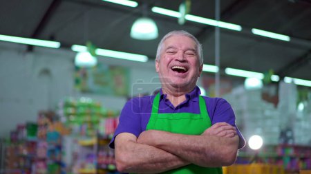 Photo for Joyful Supermarket Manager with Arms Crossed, smiling Expression of Older Small Business Owner Inside Store - Royalty Free Image
