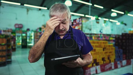 Photo for Stressed business owner of supermarket chain feeling pressure facing difficulties in grocery store operations. Portrait of a frustrated manager with unshaven beard and gray hair - Royalty Free Image