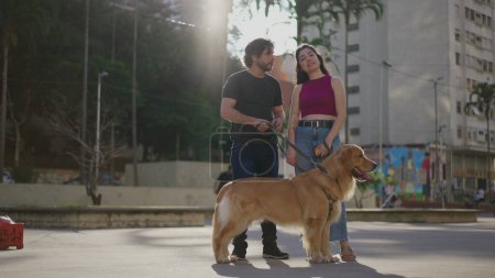 Photo for Couple in city_ A Candid Outdoor Millennials with their Beloved Purebred Golden Retriever. Authentic weekend activity of people with their Dog Pet - Royalty Free Image