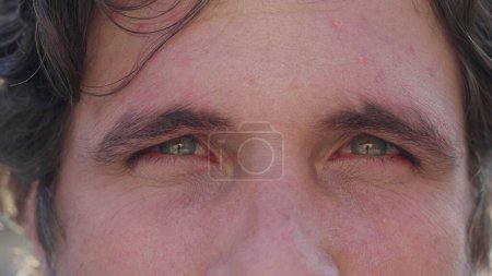 Photo for Serious man frowning to camera. Male eyesight macro closeup looking at camera - Royalty Free Image