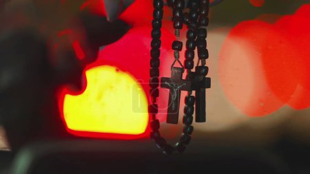 Photo for Rainy Night Drive with Christian Cross Hanging in Vehicle Windshield - Royalty Free Image