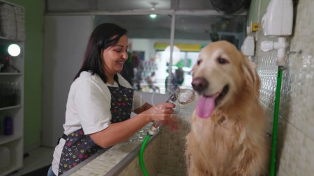 Photo for Happy Brazilian Employee Washing Dog at Pet Shop - Royalty Free Image