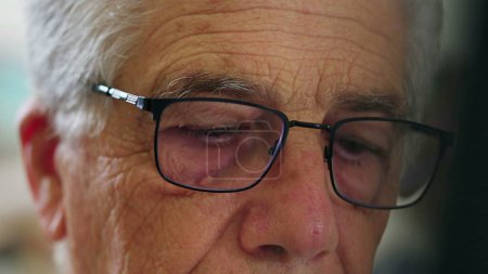 Photo for Close-up of senior man wearing glasses in front of laptop computer engaged with modern technology. Detail face of elderly person staring at screen, browsing internet online activity - Royalty Free Image