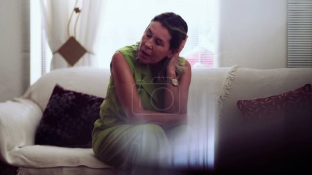 Photo for Neurotic older woman sitting at home couch struggling with preoccupation and ruminations, anxious lady - Royalty Free Image