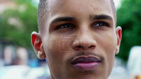 Photo for One thoughtful Brazilian young black man close-up face. Contemplative expression of a South American person pondering life - Royalty Free Image