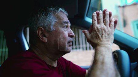 Photo for Religious senior man Praying to God during difficult times while sitting inside vehicle, parked in street looking at sky asking for divine help - Royalty Free Image