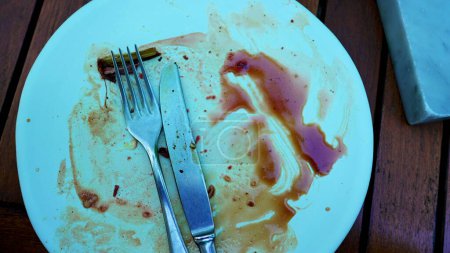 Photo for Dining Aftermath of Empty Plate with Meal Residue. Plate leftovers, finished plate - Royalty Free Image