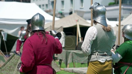 Photo for Guardians of the Past, Soldiers Poised with Spears at Reenactment Festiva. Soldiers with steel helmets at Historical Fair on Standby - Royalty Free Image