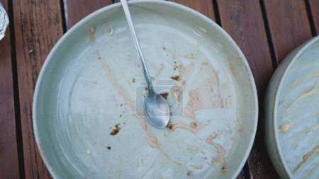 Photo for After the Indulgence of Remnants on Plate Post Gourmet Dessert, Spoons Tell the Tale - Royalty Free Image