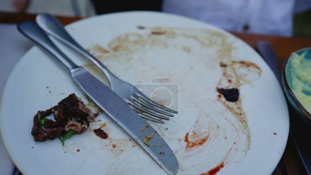 Photo for Plate leftovers, finished plate, Dining Aftermath Empty Plate with Meal Residue - Royalty Free Image