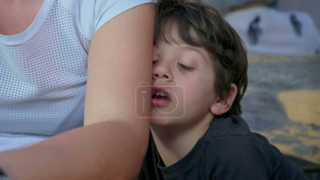 Photo for Bored child hiding behind mother's arm feeling boredom, close-up of shy kid with nothing to do - Royalty Free Image